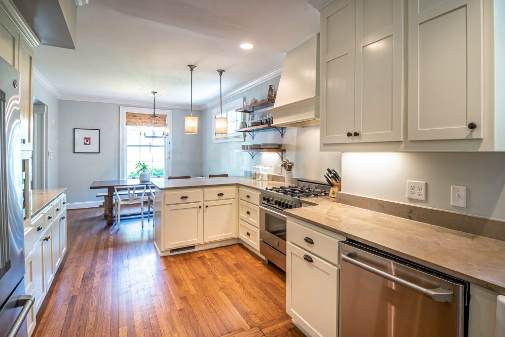 kitchen remodel. white counters and wood flooring.